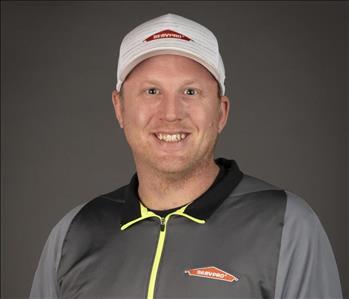 male servpro employee in front of blank background with gray shirt