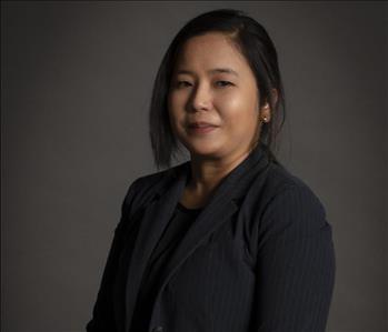 female servpro employee wearing business attire in front of blank background