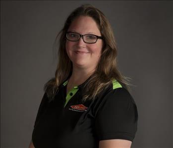 female servpro employee wearing polo in front of blank background